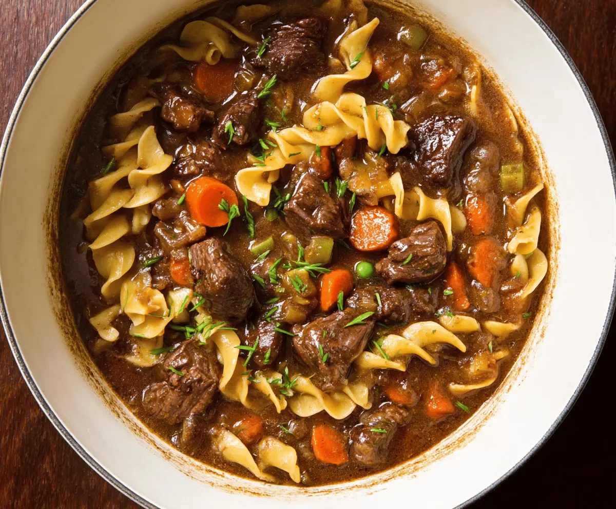 Delicious homemade beef stew with tender beef chunks, vegetables, and noodles served in a bowl