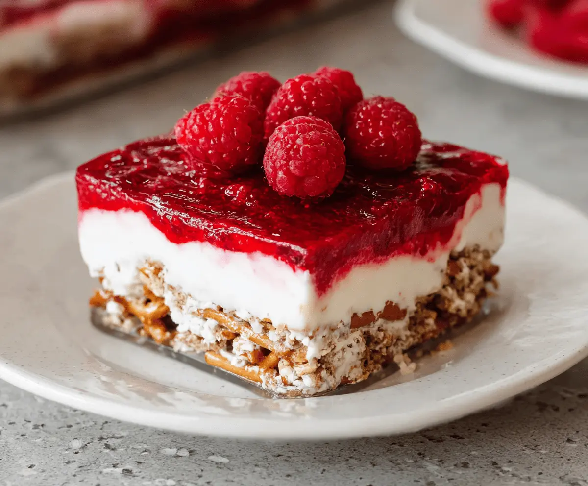 Delicious gluten-free raspberry pretzel salad with fresh berries and crunchy pretzels.