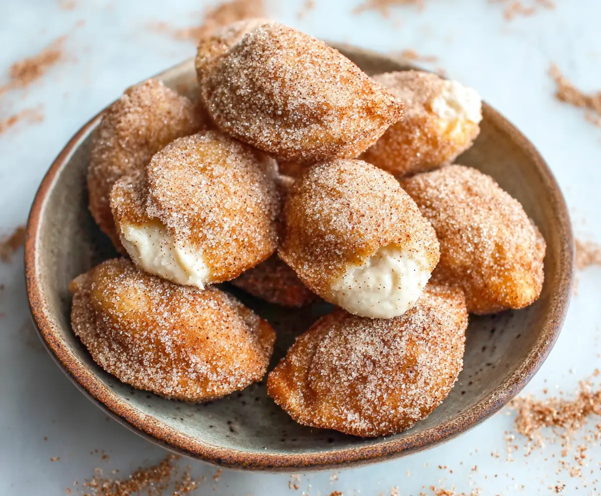 Delicious Cinnamon Cream Cheese Bites on a serving plate, perfect for snacks or parties.