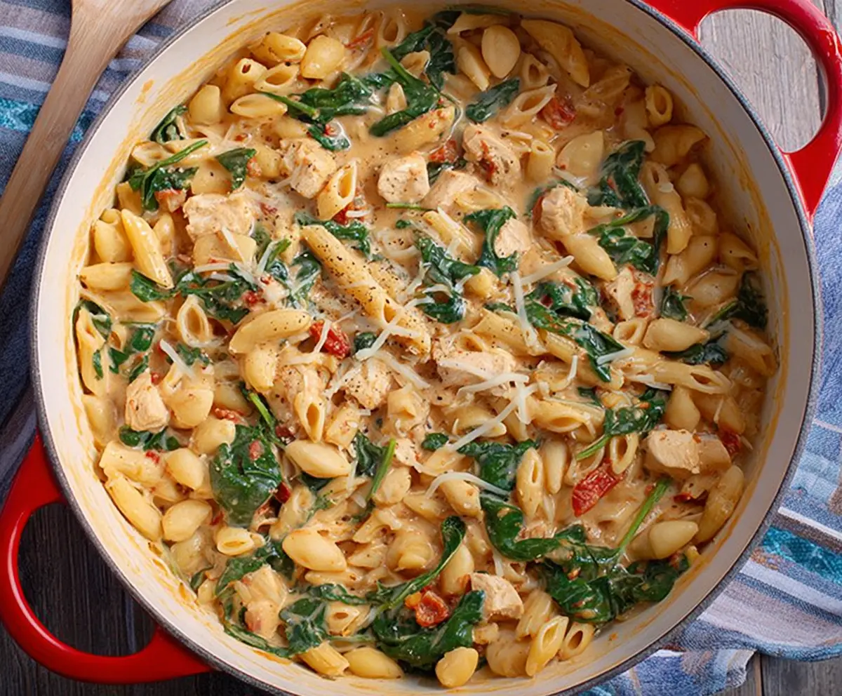 Delicious One Pot Tuscan Chicken Pasta with creamy sauce and fresh herbs on a plate.