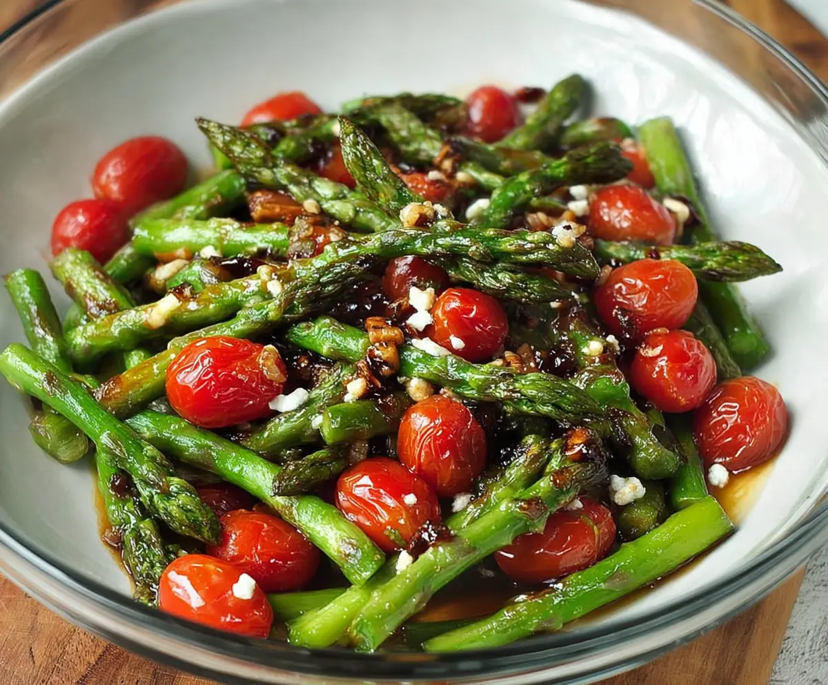 Colorful balsamic asparagus and tomato salad on a white plate, fresh and vibrant for a healthy summer dish.