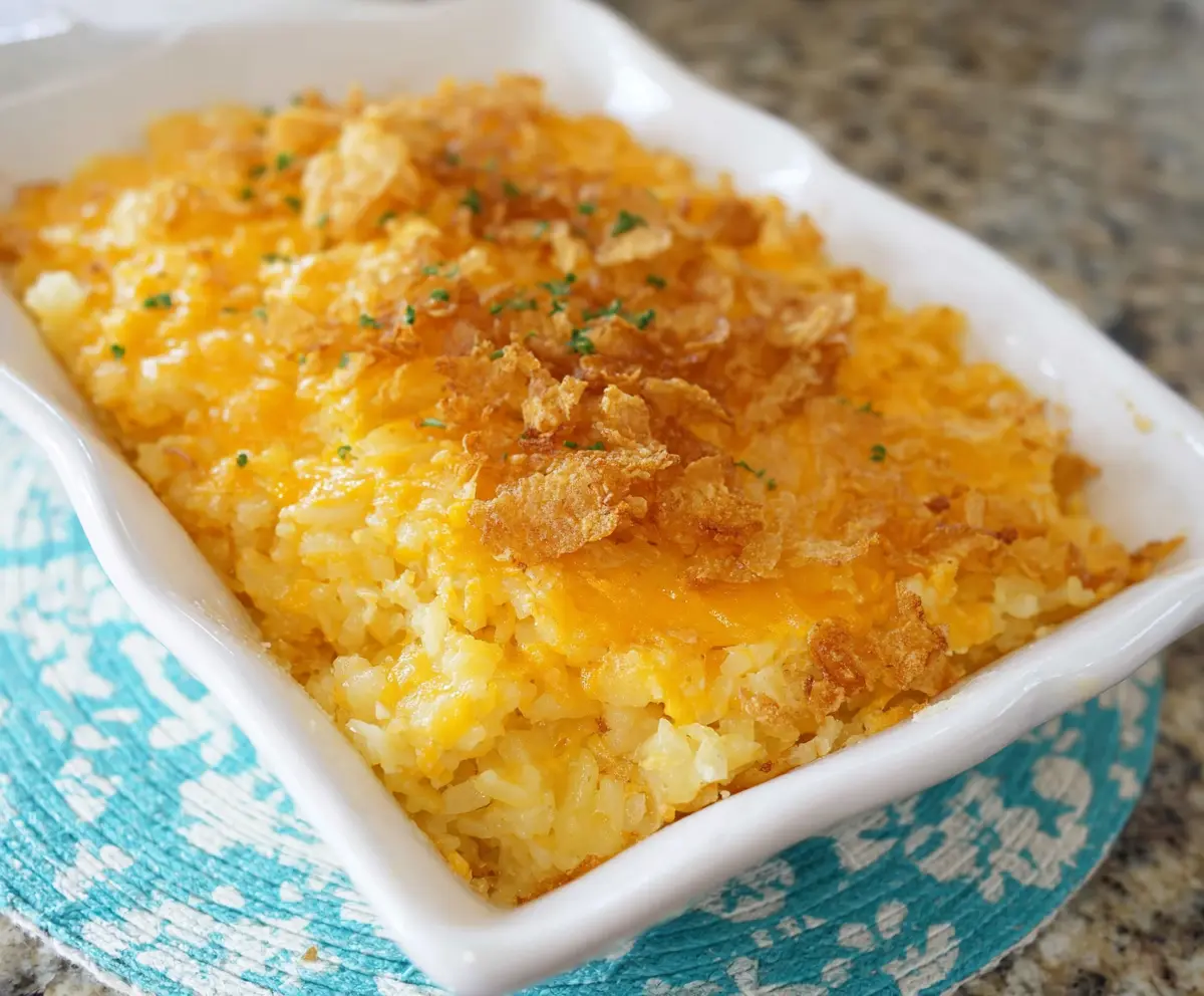 Delicious cheesy hashbrown casserole topped with golden melted cheese and crispy edges.