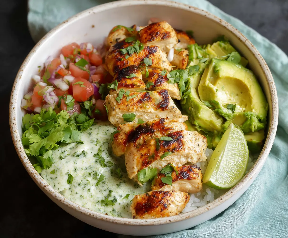 Delicious cilantro lime chicken bowls served with fresh vegetables and rice