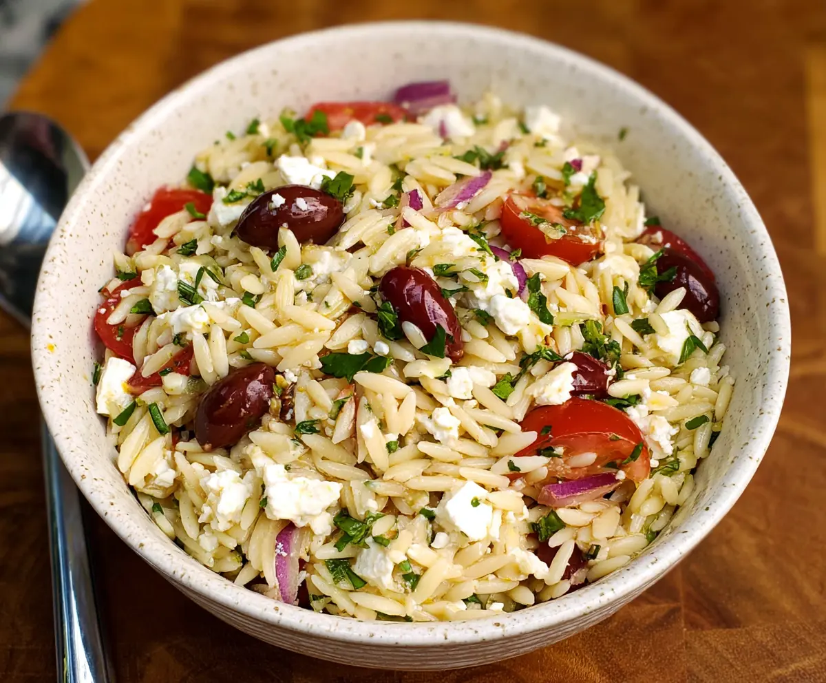 Fresh Feta Orzo Salad with cherry tomatoes, cucumbers, and herbs, perfect for a light summer meal.